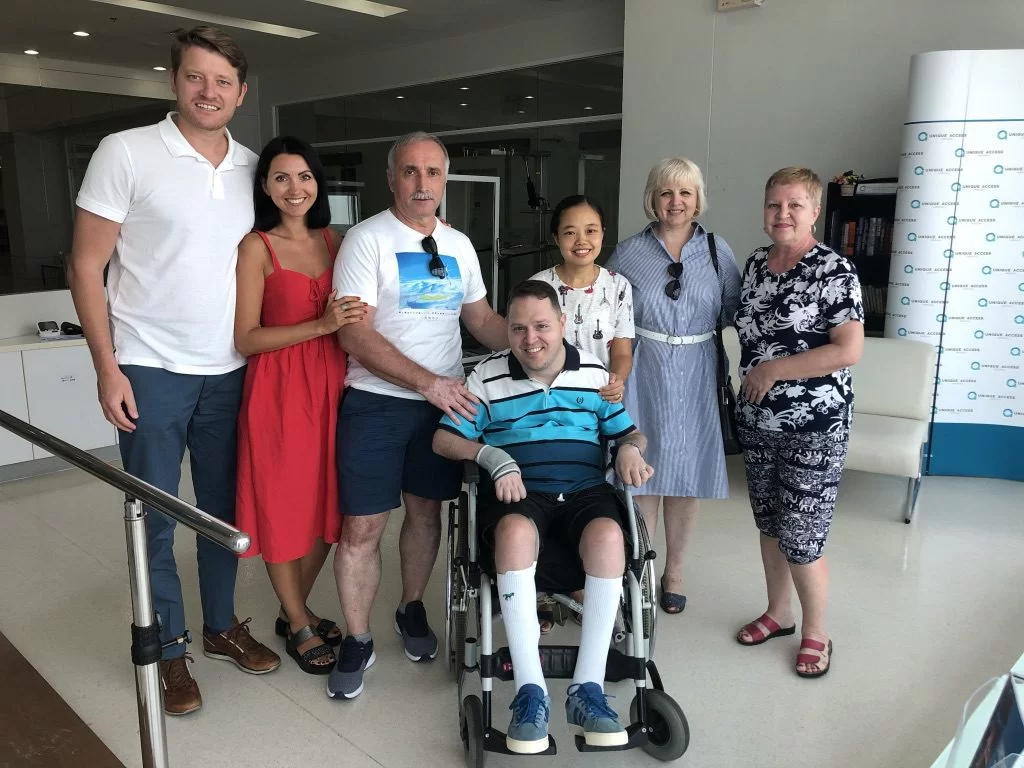 Gabi Iordache surrounded by friends and members of his care team